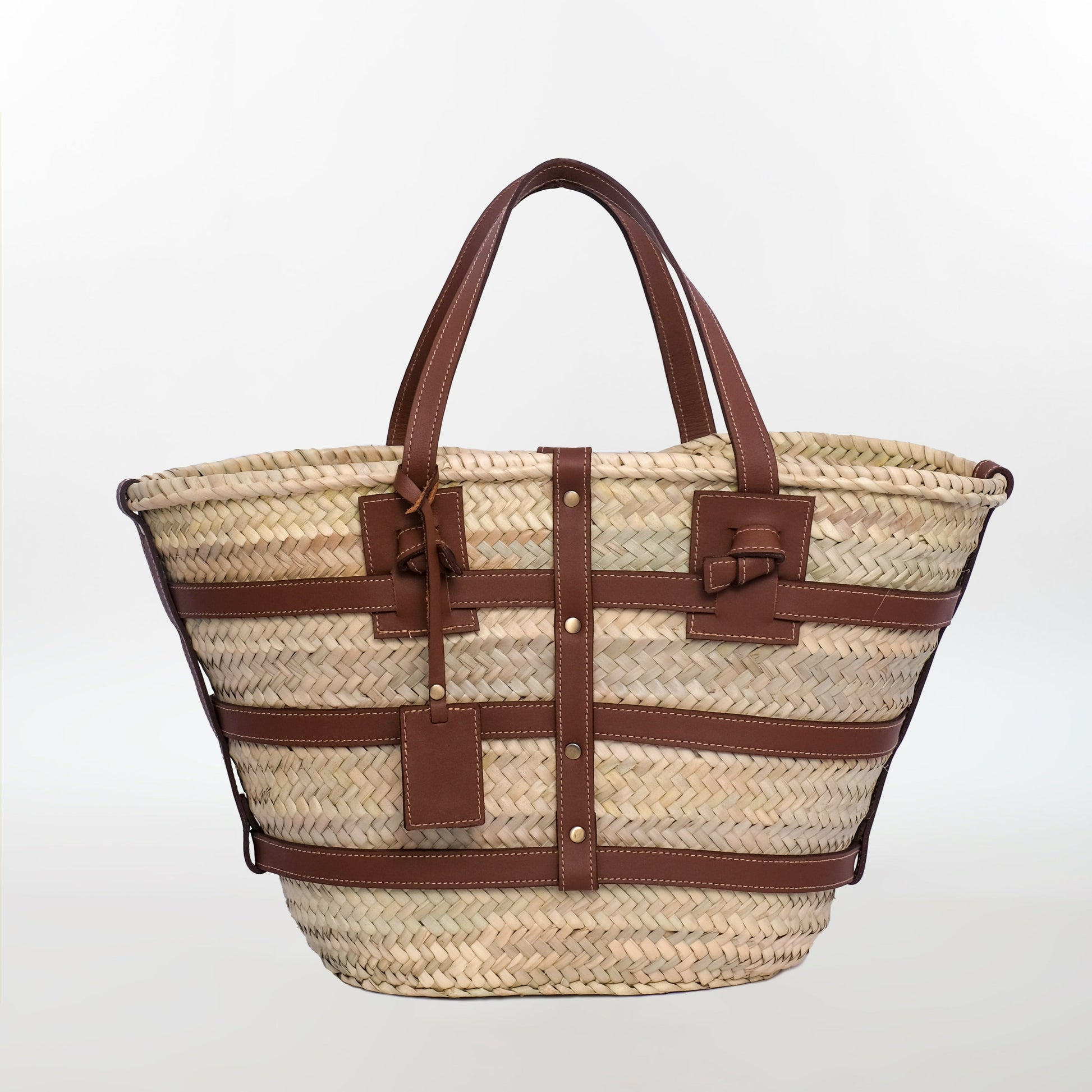 Classic Moroccan straw tote bag with leather trim, stitched handles, and a tag charm