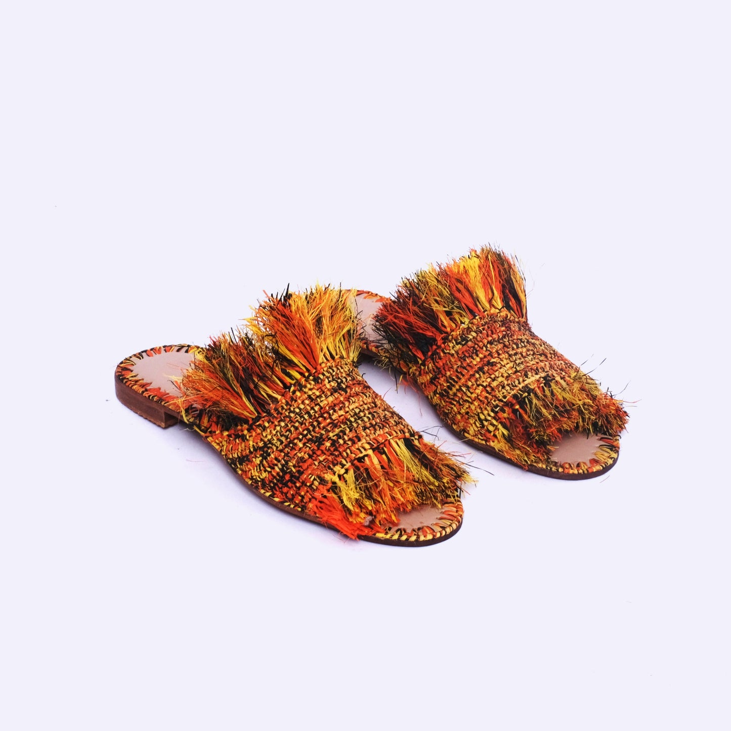 Colorful Moroccan raffia slides with bold sunset-toned fringe and flat leather sole