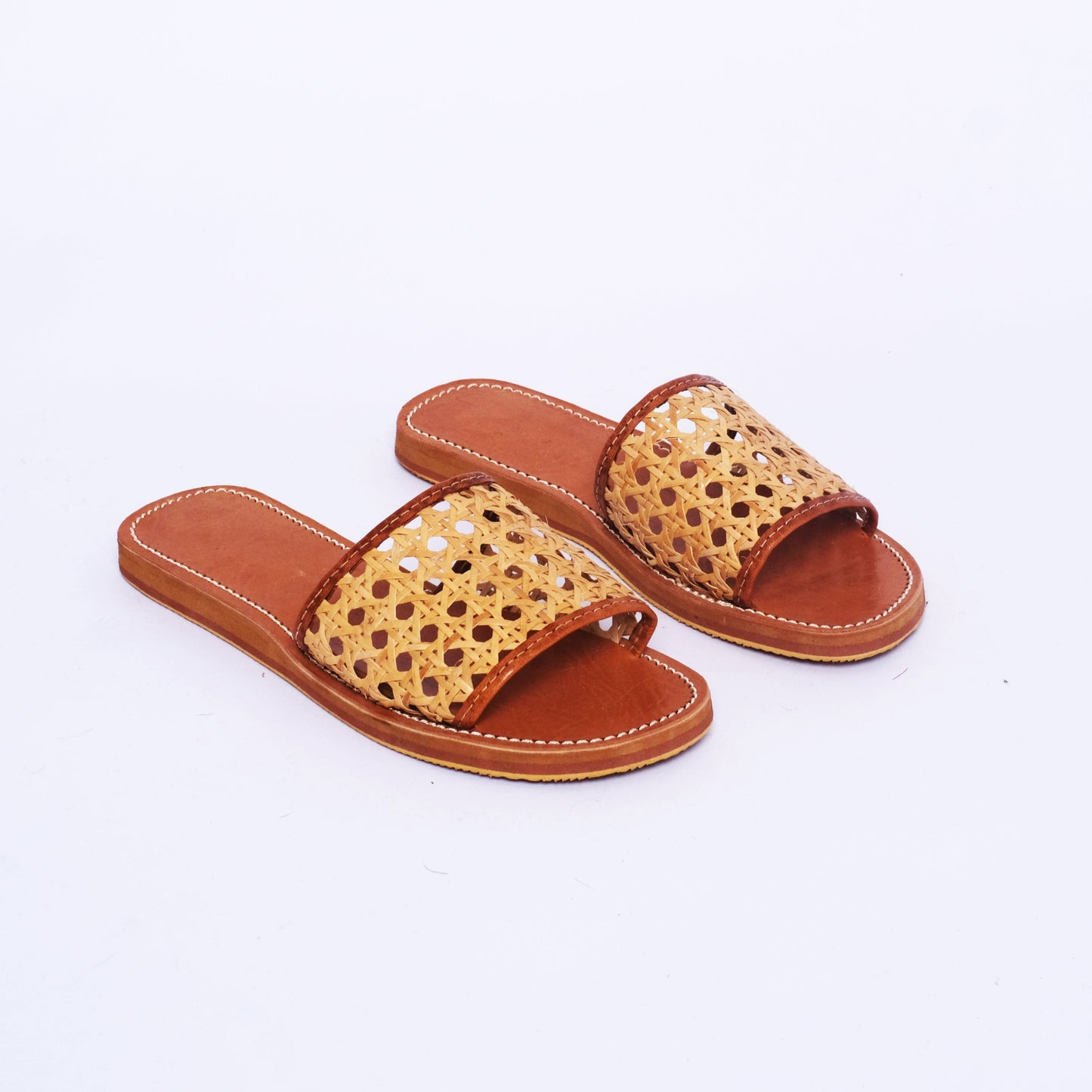 Handwoven cane slide sandals with leather sole in natural tan color