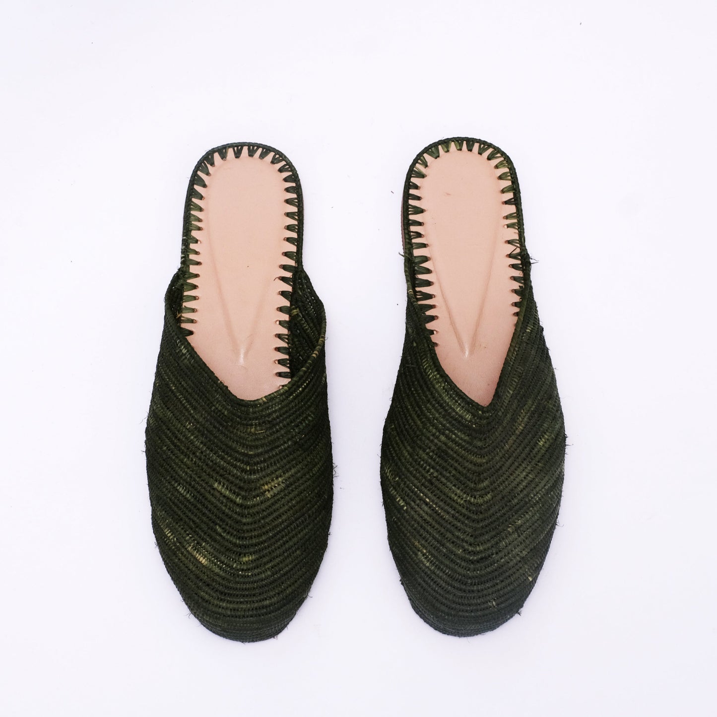 Women’s dark green raffia mules with V-cut front and natural leather insole, handwoven in Morocco from palm fiber.