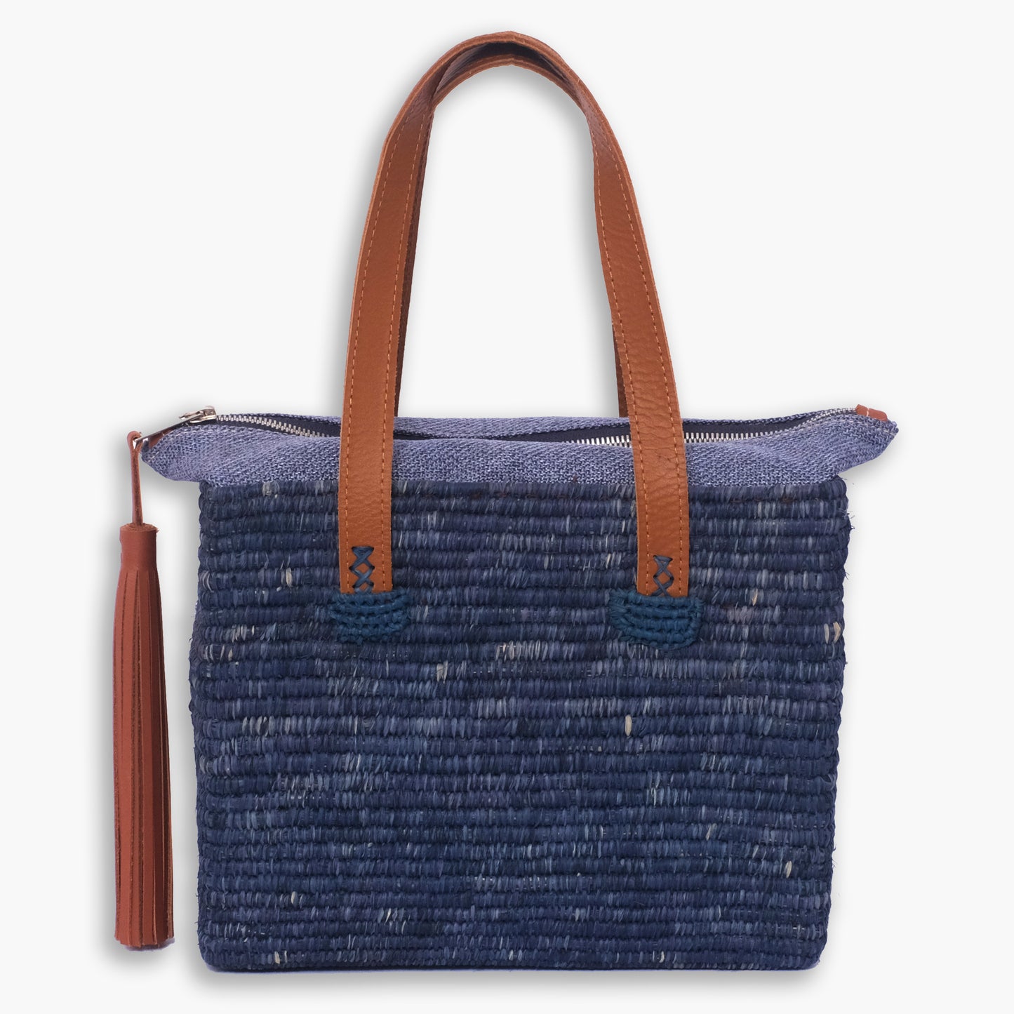 Indigo raffia tote bag with brown leather handles, top zipper closure, and leather tassel pull