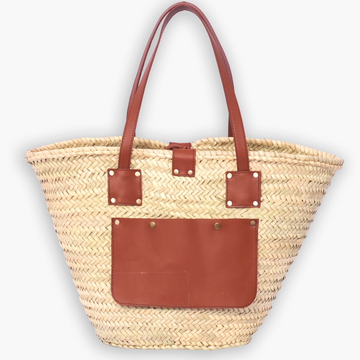Moroccan straw tote bag with square leather strap anchors and a large front leather pocket, photographed on a white background.