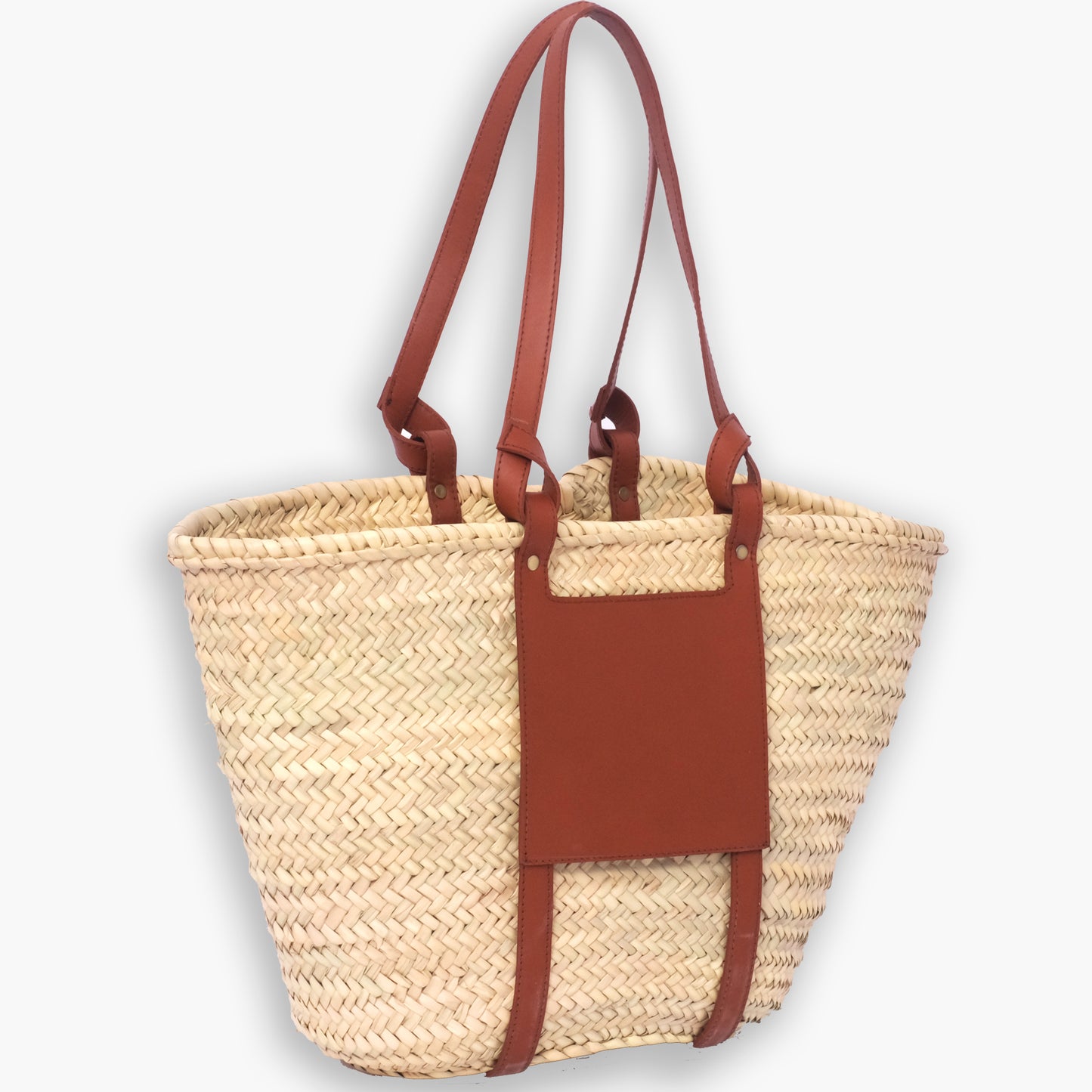 Handwoven Moroccan straw tote with a vertical leather panel and looped leather straps, shown against a white background.
