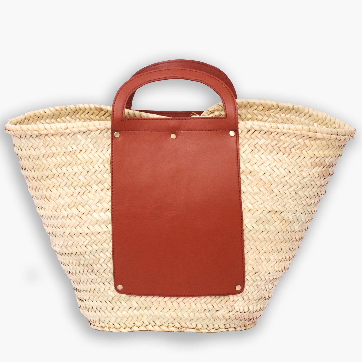 Structured Moroccan straw tote with full leather front panel and cutout top handle, photographed on a white background.