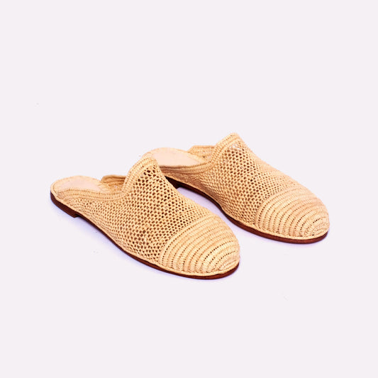 Handwoven raffia mules with mesh body and solid woven toe cap, flat leather sole, slip-on design, handmade in Morocco.