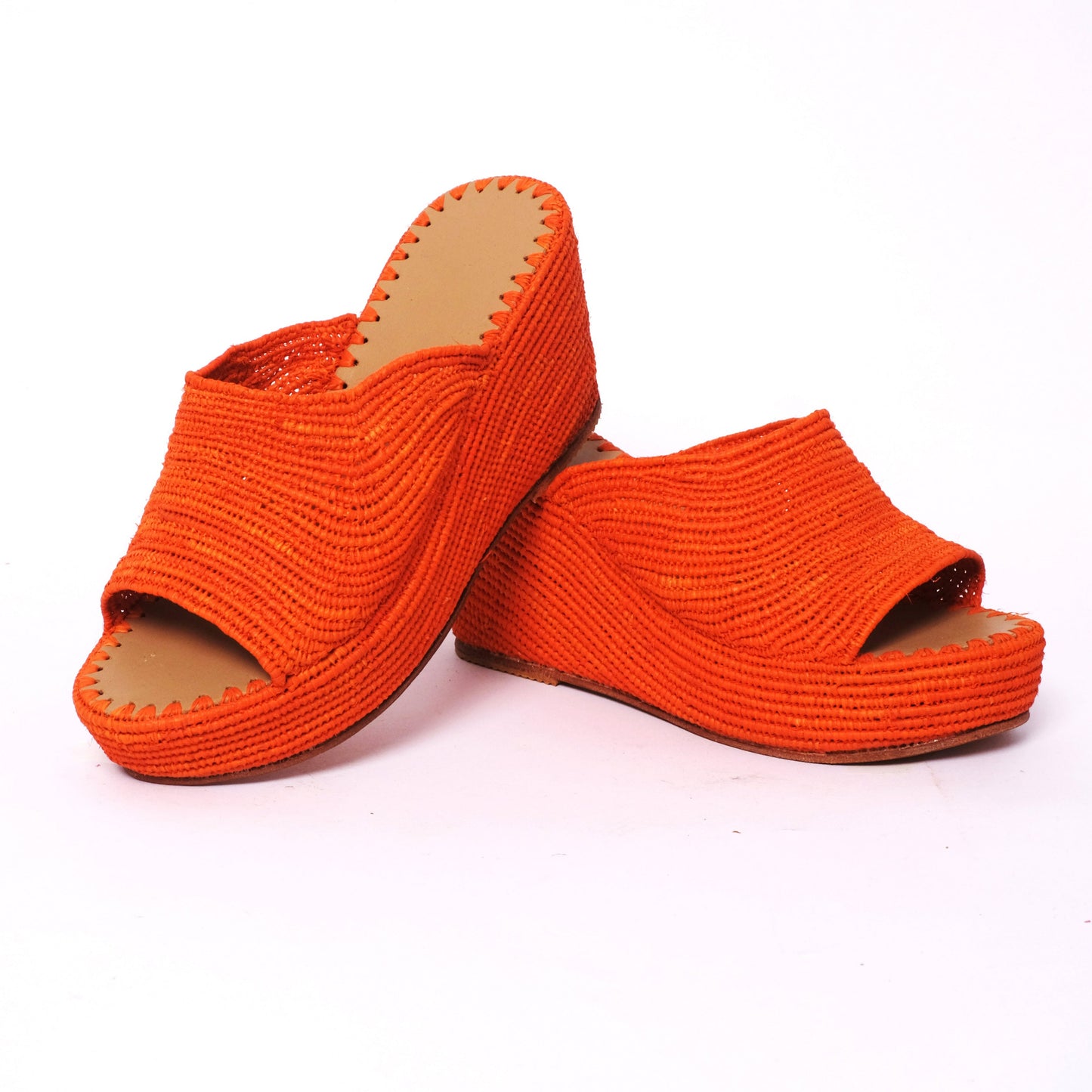 Bold orange raffia wedge mule sandals with handwoven platform sole