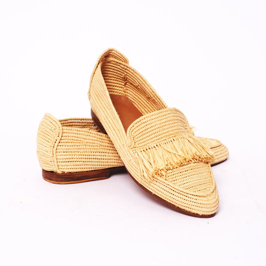Women’s pointed-toe raffia loafers in natural color with a fringe detail across the vamp, handwoven in Morocco with a flat leather sole.