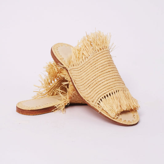 Natural raffia slides with full fringe edge and wide band upper, handmade in Morocco . 