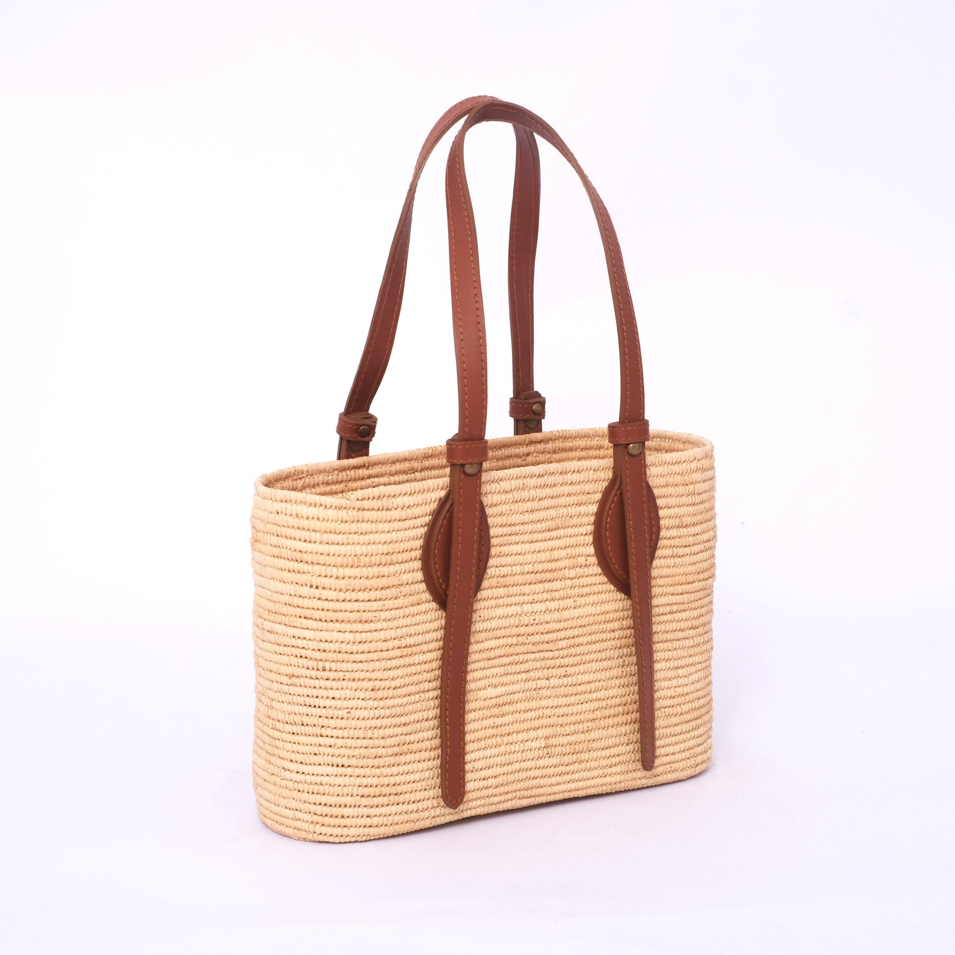 Classic raffia tote bag with long brown adjustable leather shoulder straps
