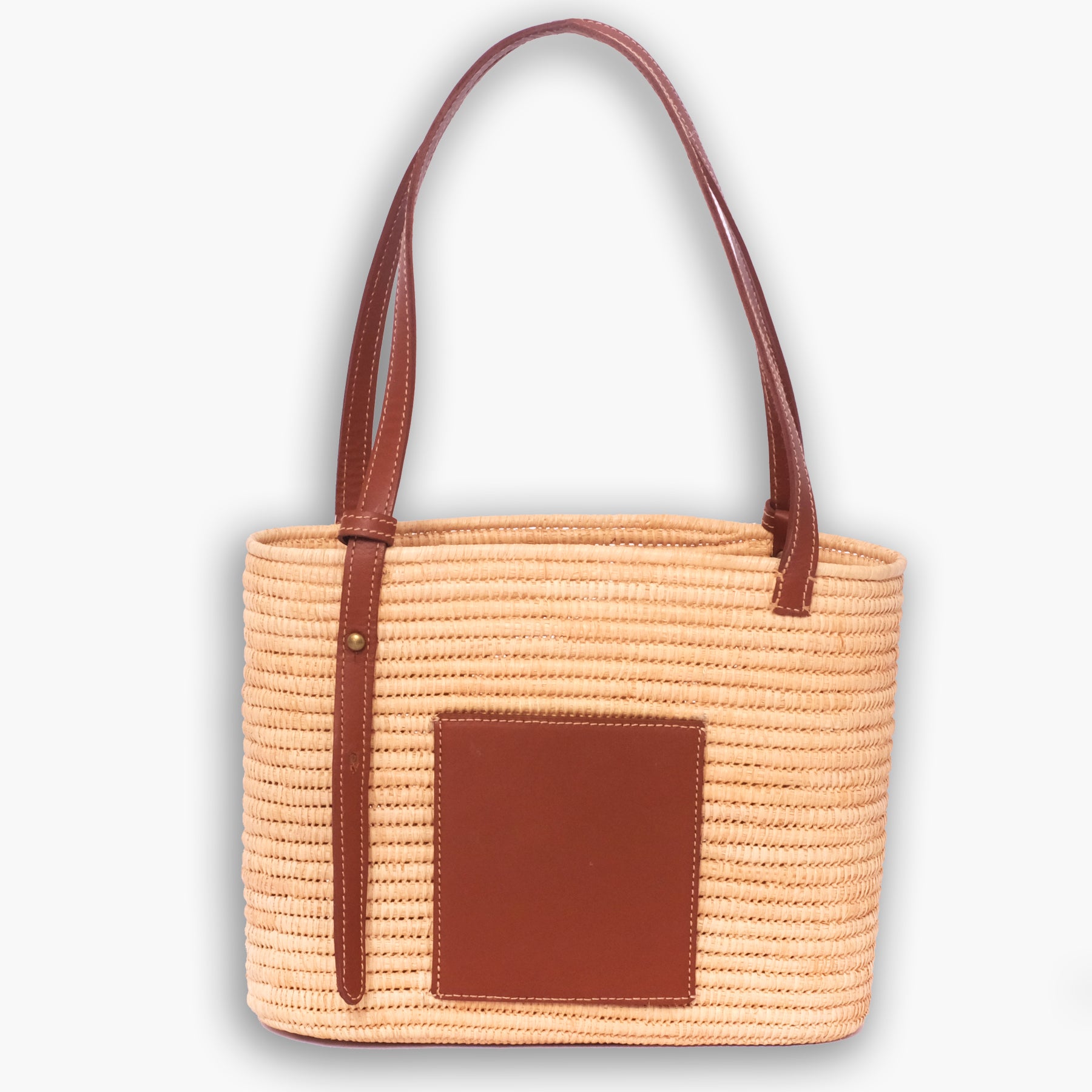 Natural raffia shoulder tote with long leather handles and a minimalist brown leather patch