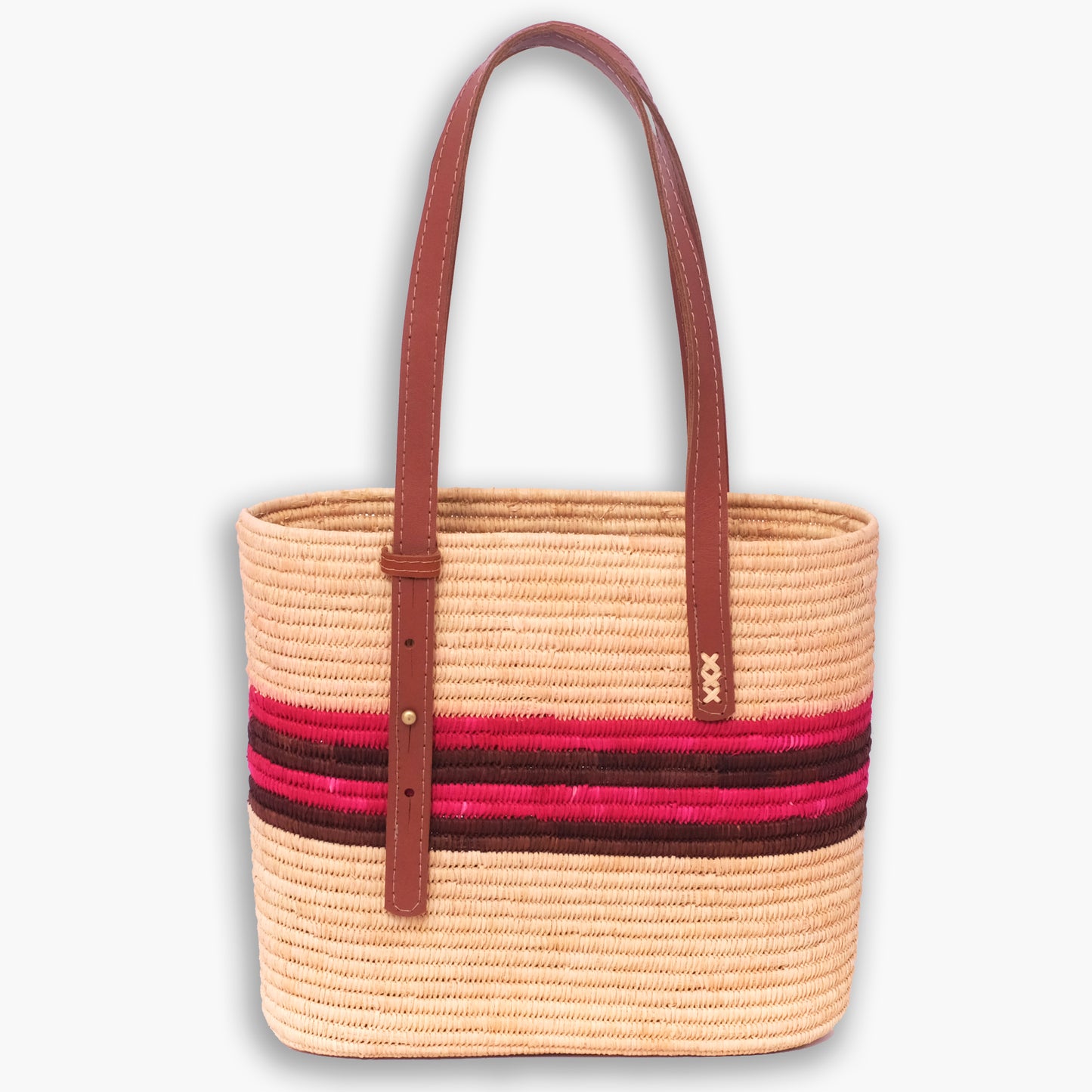 Handwoven raffia shoulder tote with pink and brown horizontal stripes and long brown leather straps